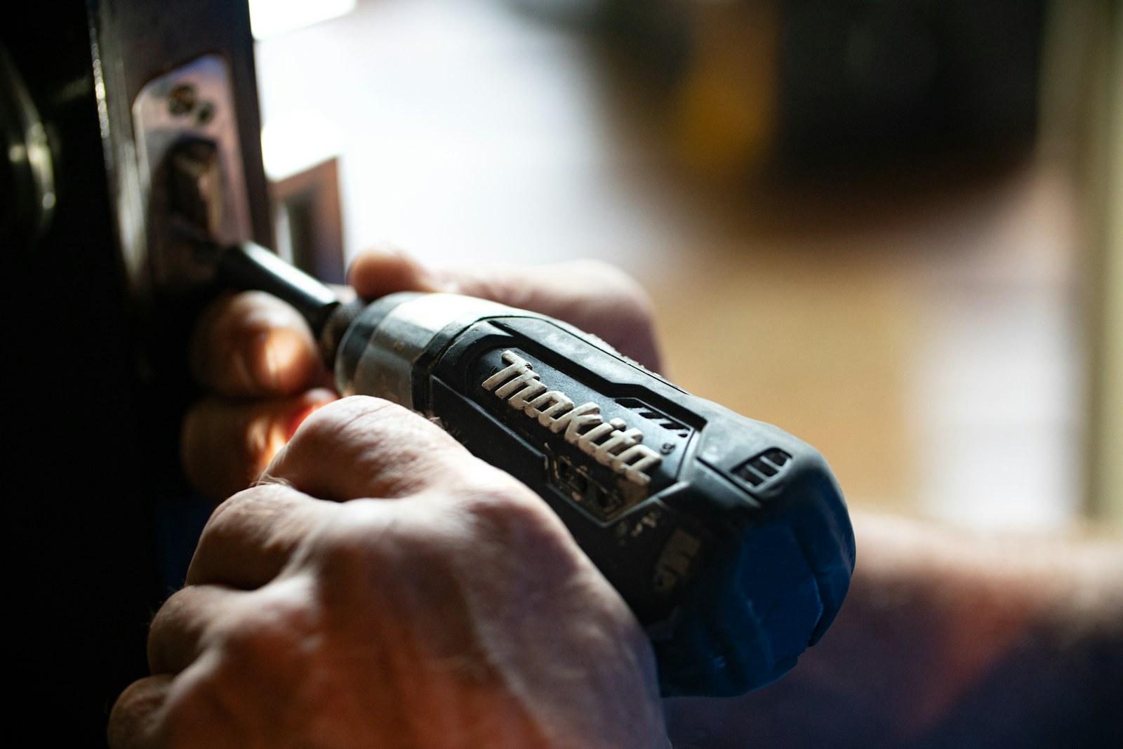Woodworker shaping a piece of wood in a workshop